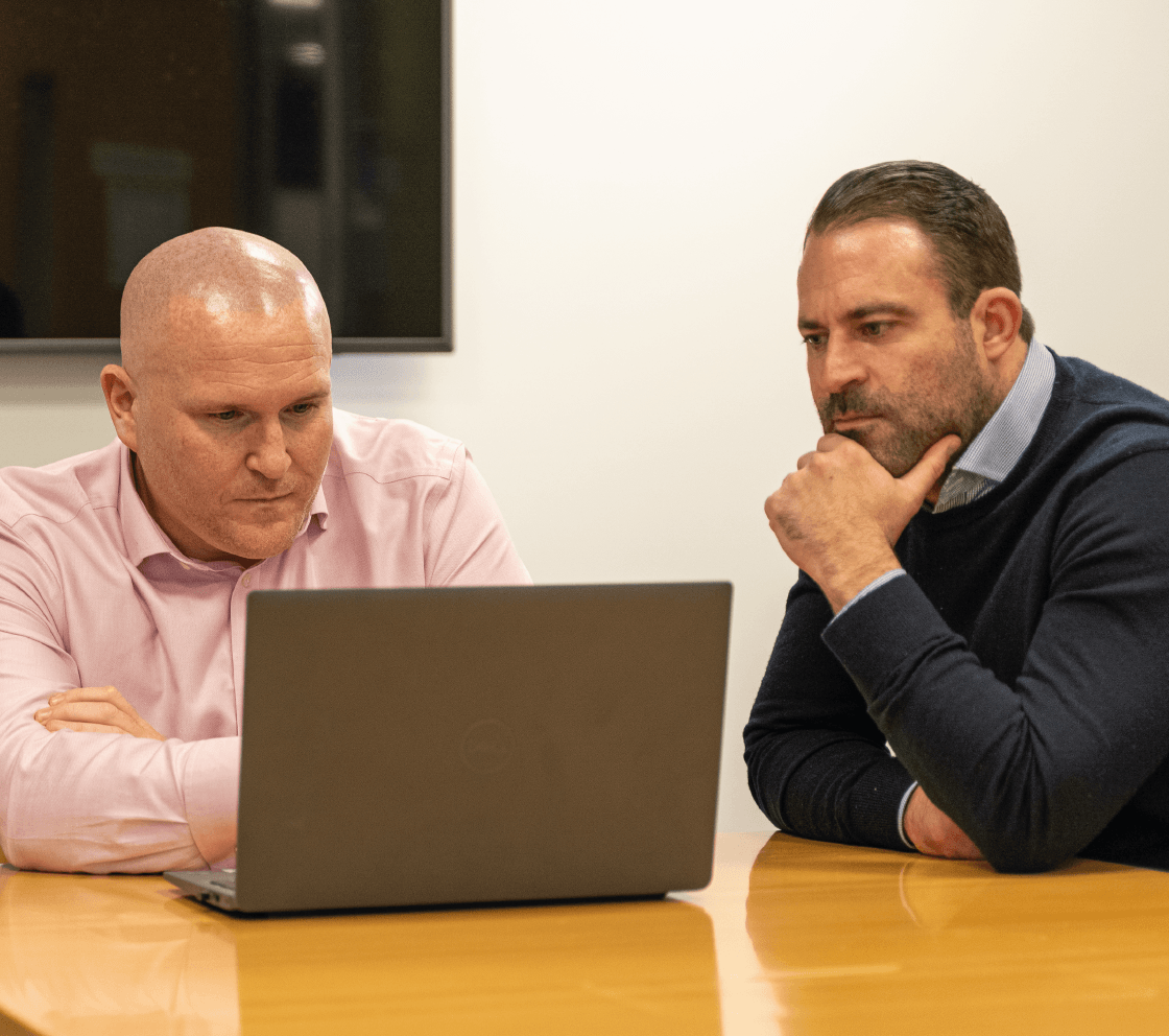 united living employees reviewing building safety reports on laptop