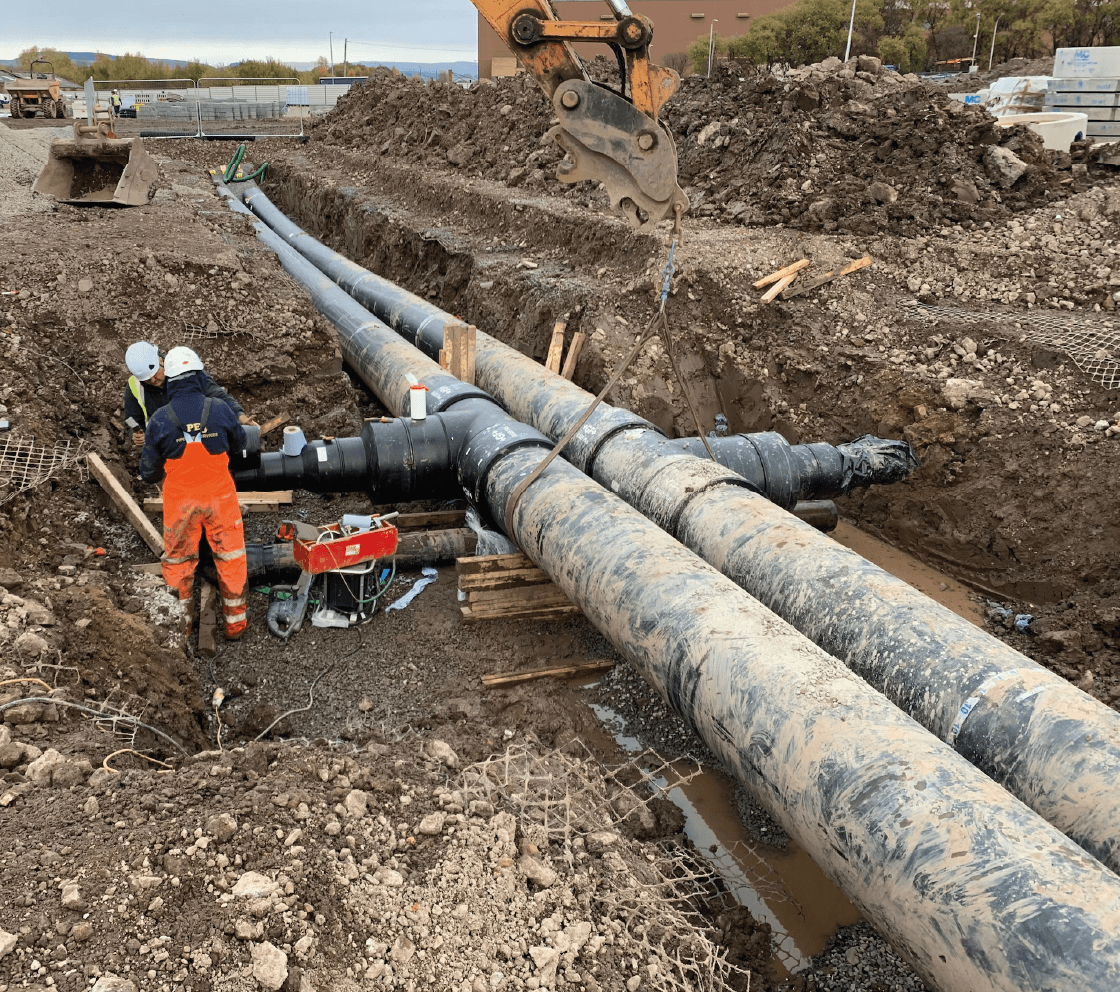 workmen laying new energy pipe infrastructure