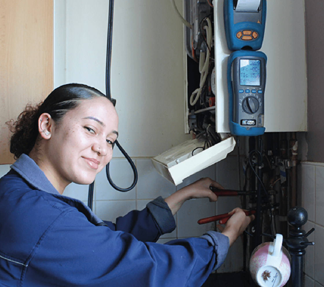 employee doing maintenance work on resident boiler