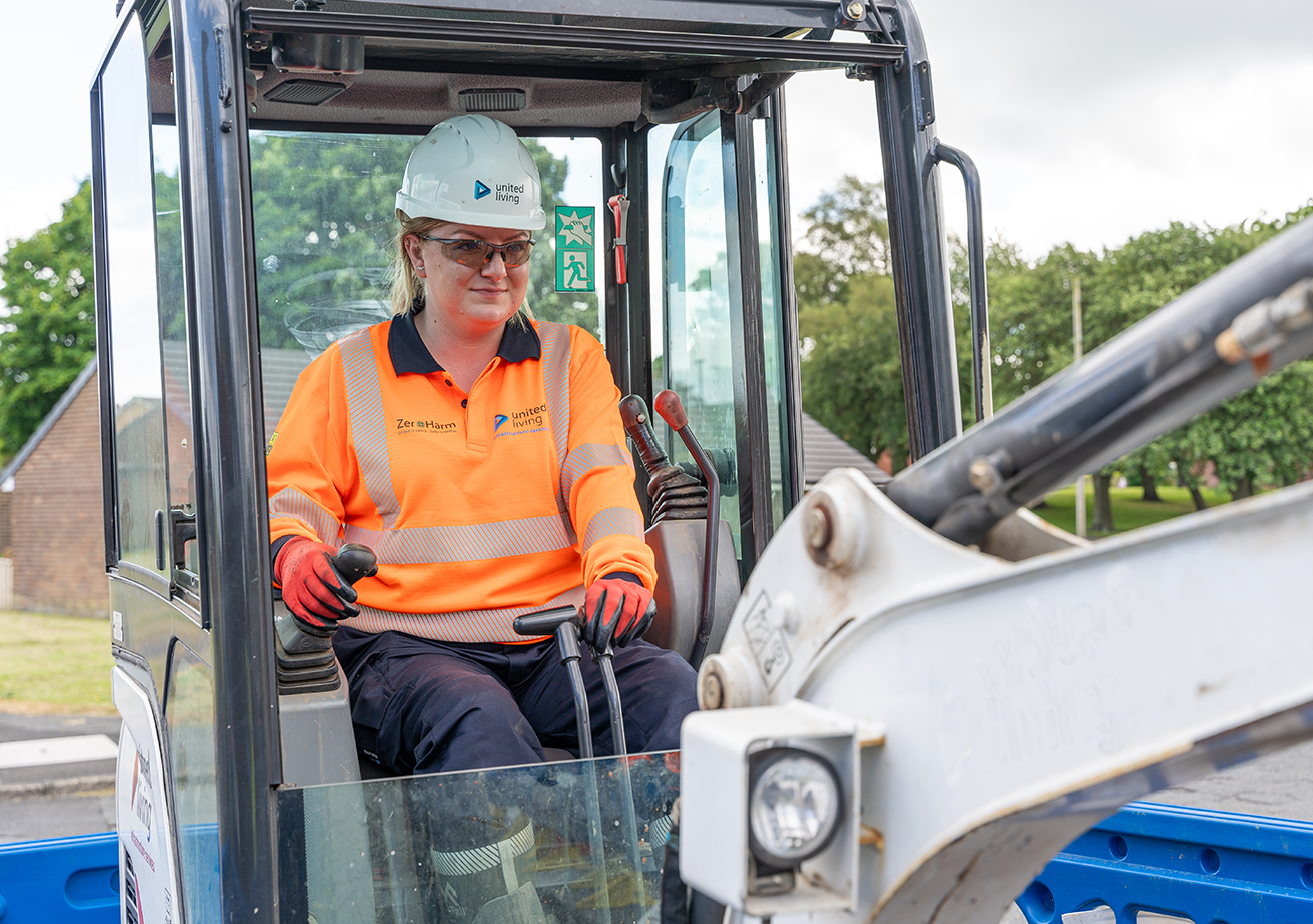 female construction worker operating digger