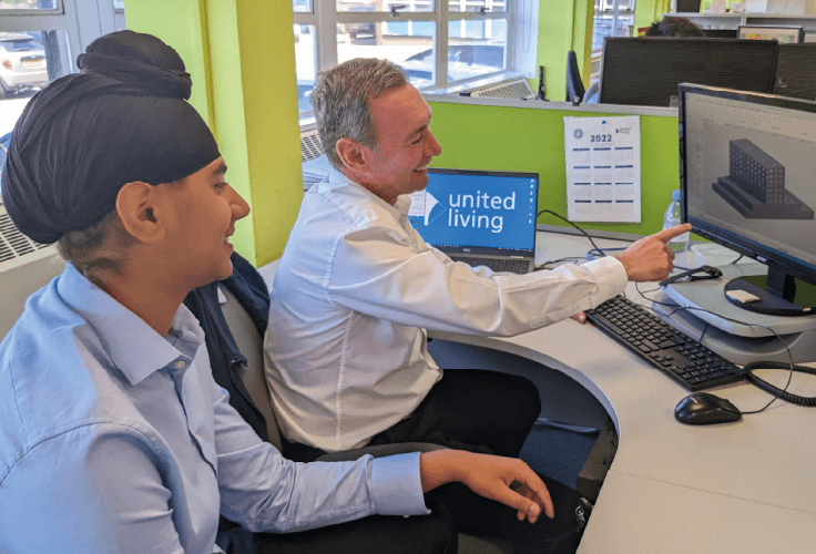 apprentice sat at desk with mentor