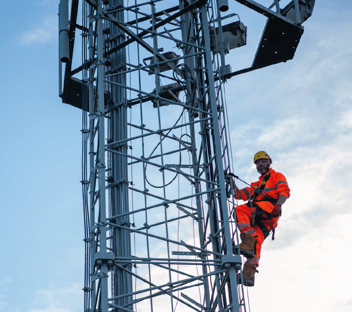 engineer performing maintenance works up telecoms tower