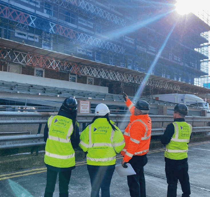 property services employees in front of scaffold building