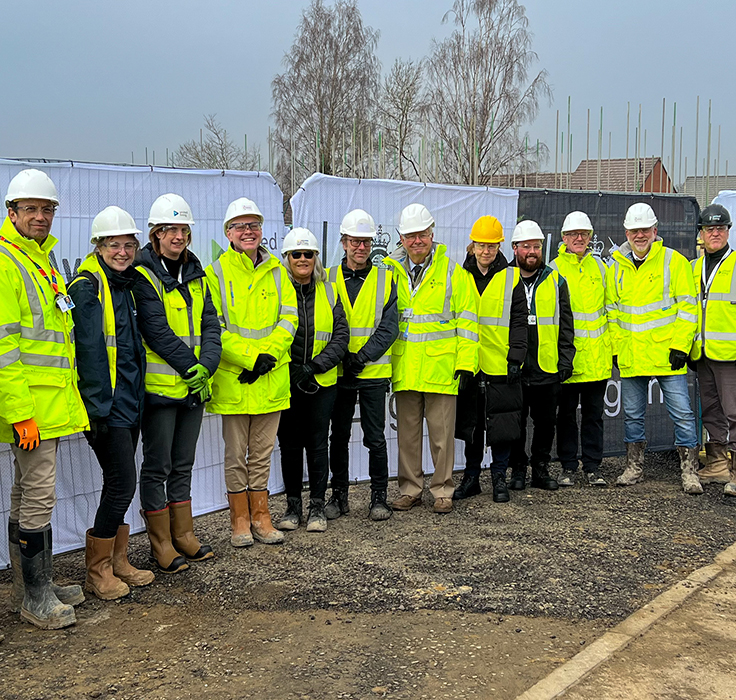 construction workers standing in front of new homes site